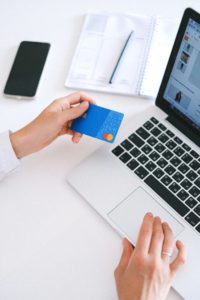 Person using credit card for online shopping